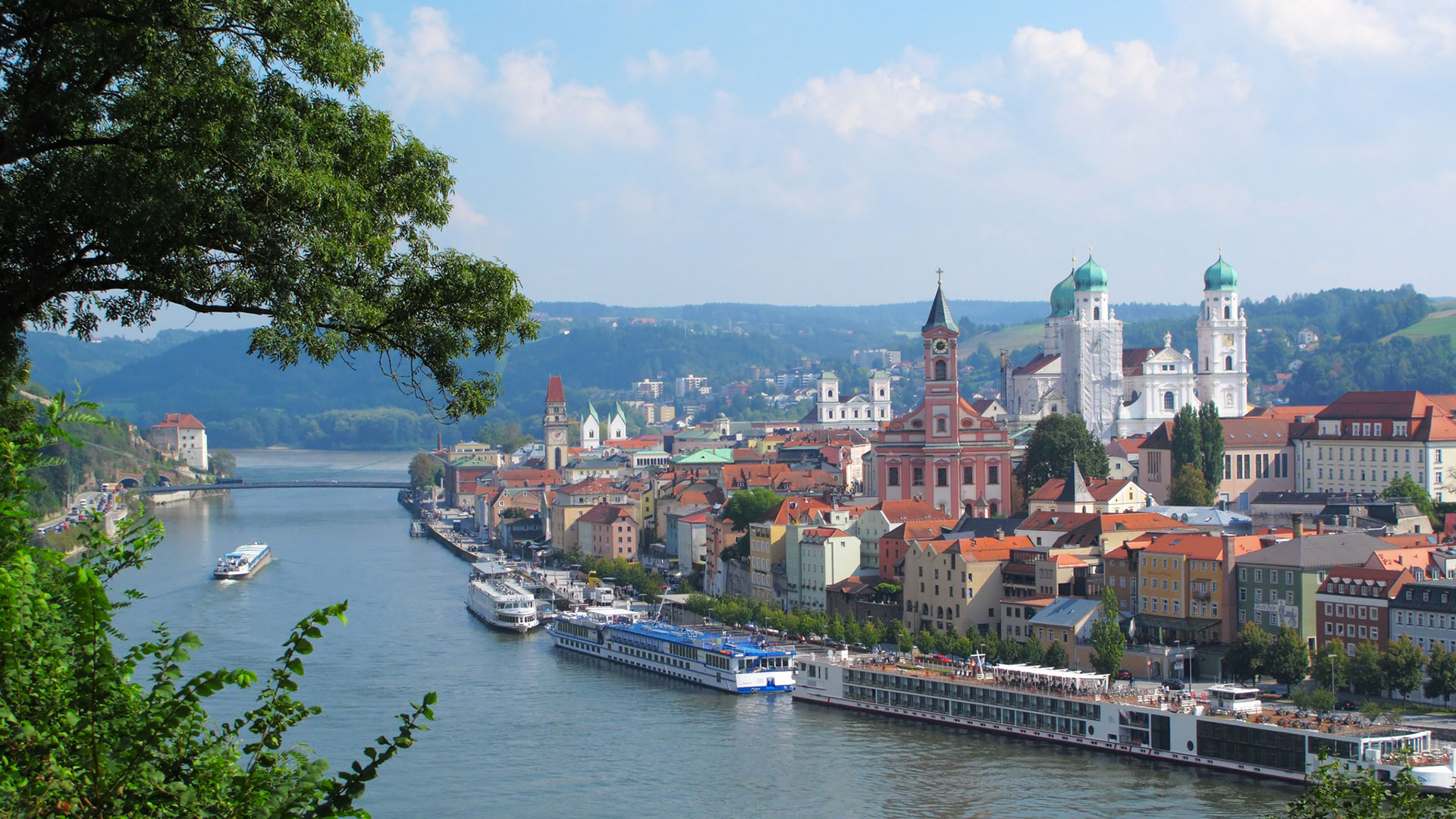 Passau’s old town and cathedral domes, with river cruise ships moored below